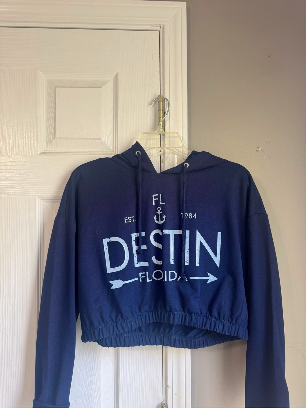 Navy blue cropped hoodie with light blue lettering